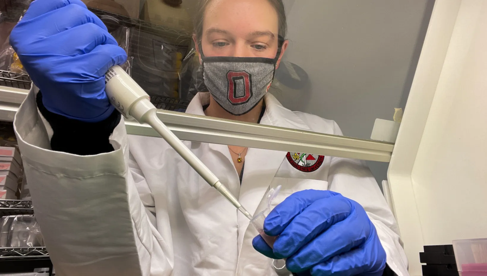 Vanessa Hale wearing Ohio State mask in a research lab 