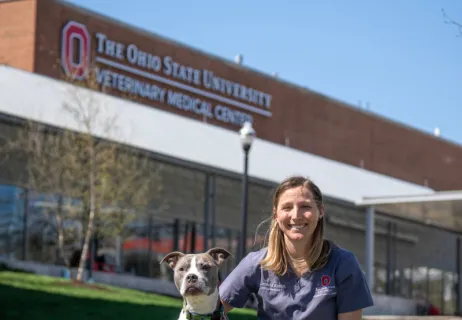 Jenessa Winston with her dog in front of the Veterinary Medical Center 