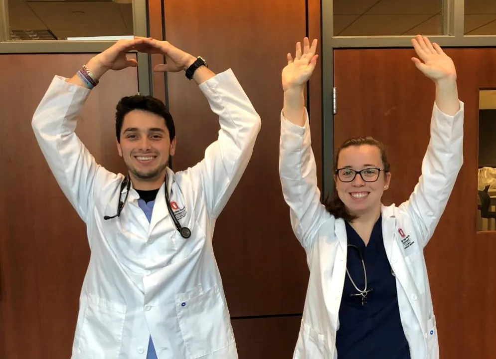 students spelling O-H with their arms in 2020