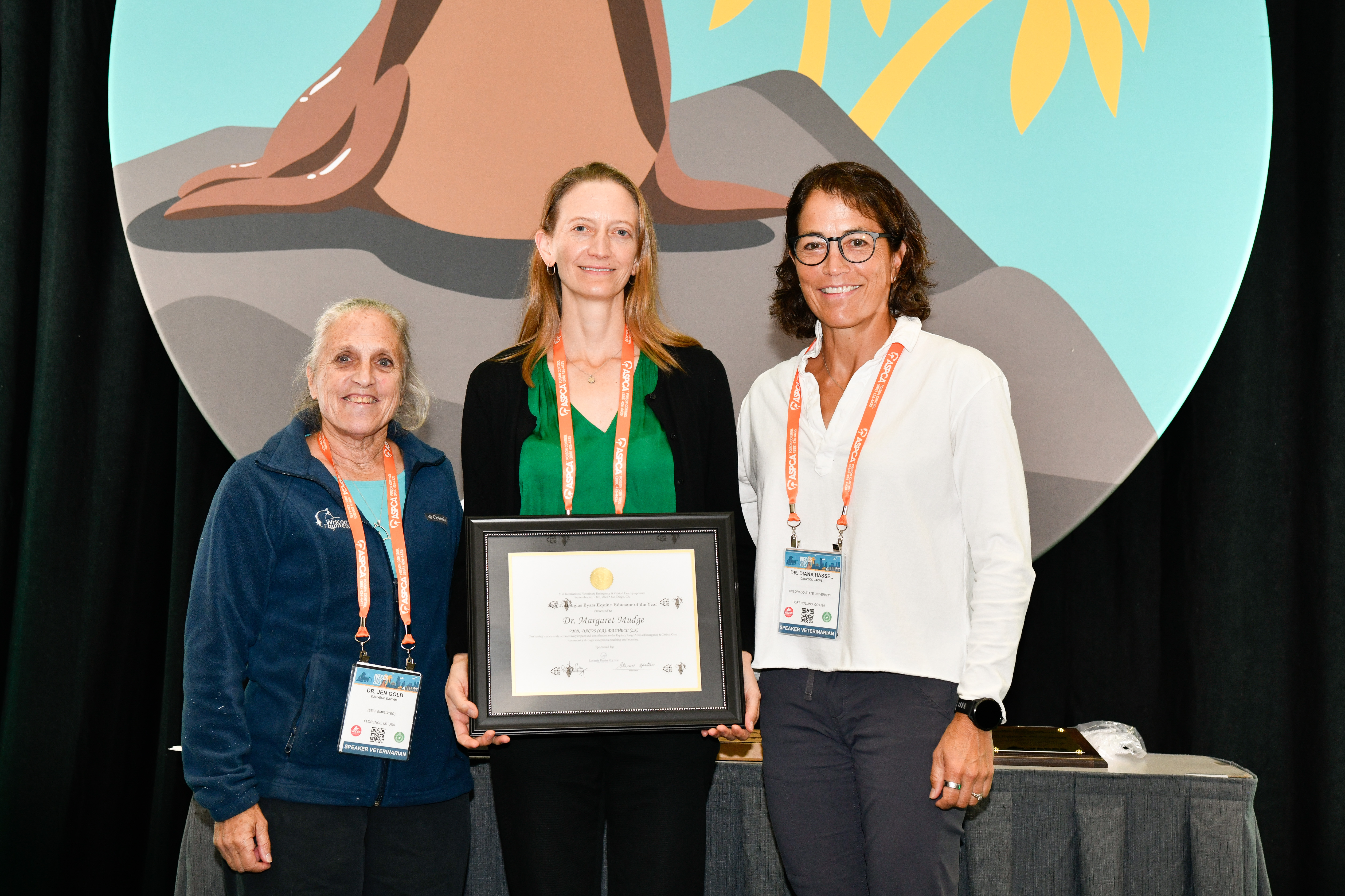 Dr. Jen Gold, Dr. Margaret Mudge and Dr. Diana Hassel pose for a photo with Dr. Mudge holding her award