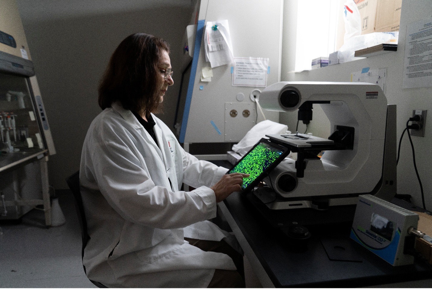 Student in research lab on tablet