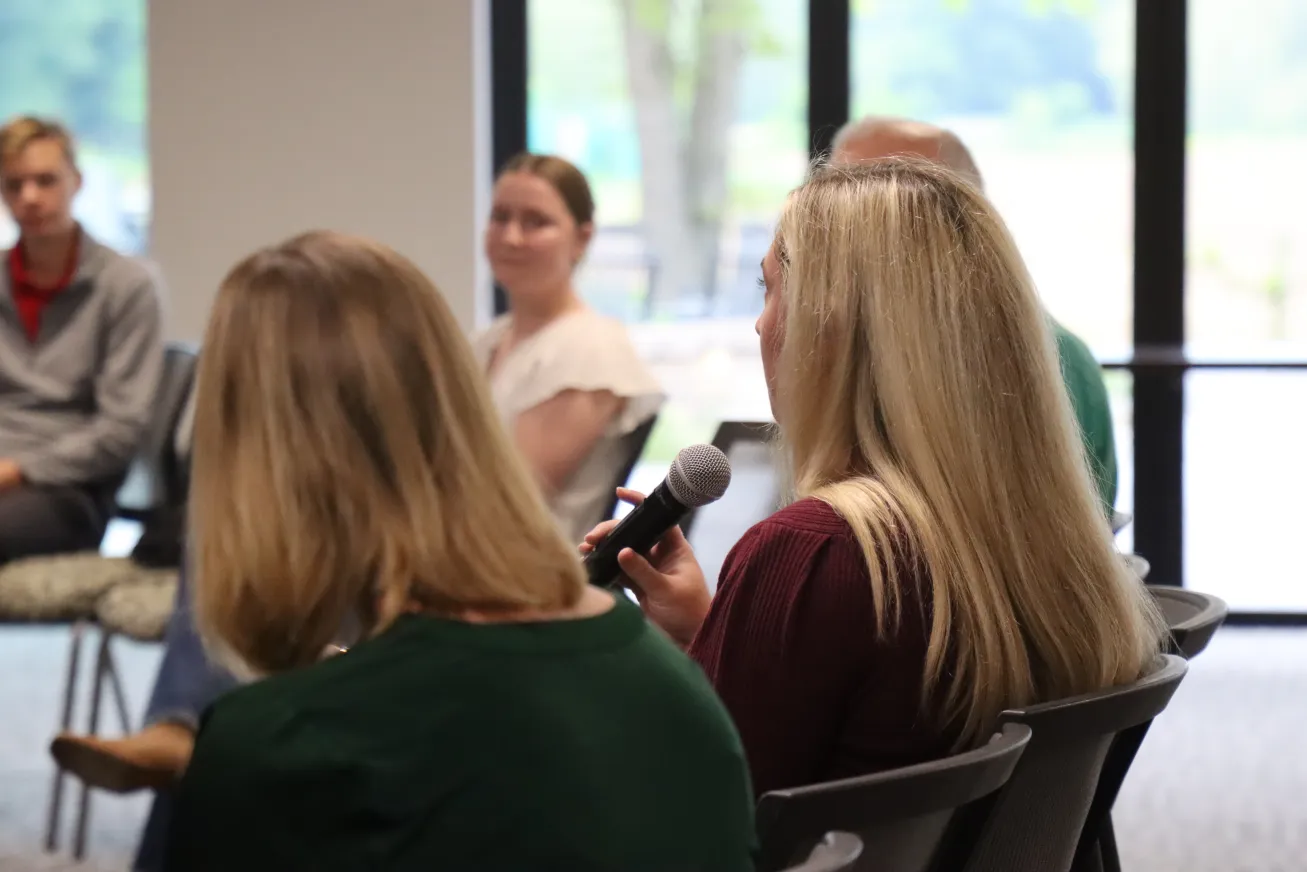 Person in the audience speaks into a microphone