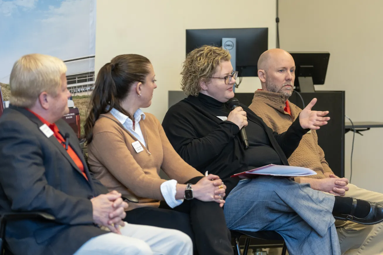 Group speaks into microphone to audience