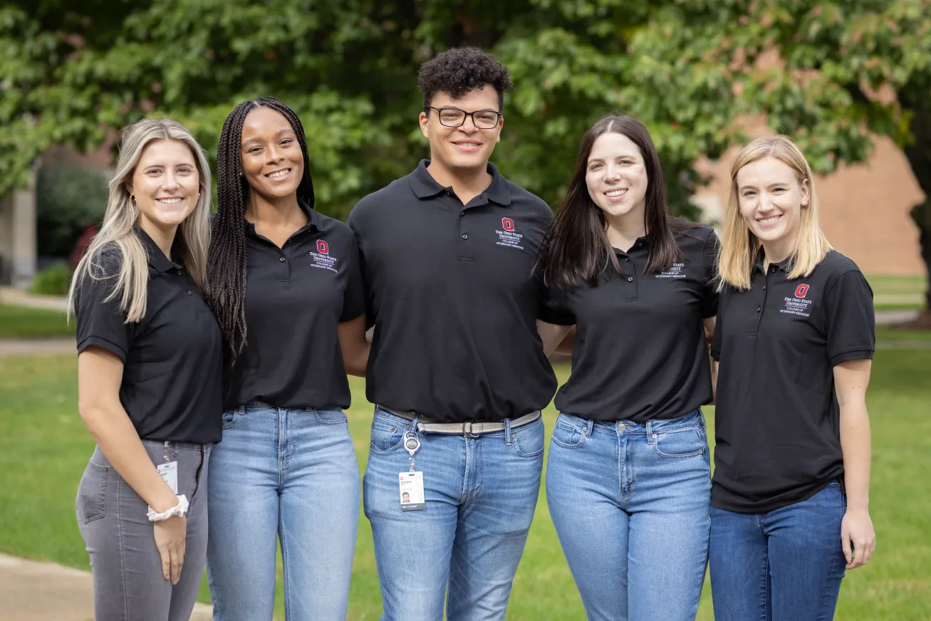 Five students posing and smiling 