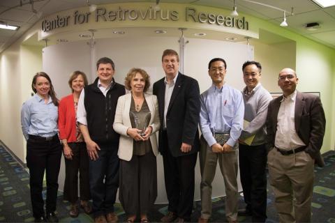 Dr. Genoveffa Franchini receives Career Award crystal from members of the Center for Retrovirus Research. Shown from left are Kristine Yoder, Karin Musier-Forsyth, Jesse Kwiek, Genoveffa Franchini, Patrick Green, Li Wu, Sanggu Kim, and Shan-Lu Liu.