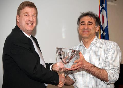 Dr. Michael Emerman (right) receives Career Award crystal from Center for Retrovirus Research Director Dr. Patrick L. Green.