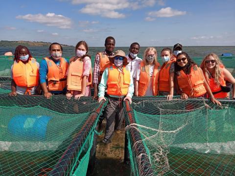 Richley at fish farm with students