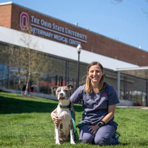 Jenessa Winston with her dog in front of the Veterinary Medical Center 