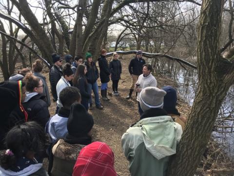 A teacher addresses a group of students. 