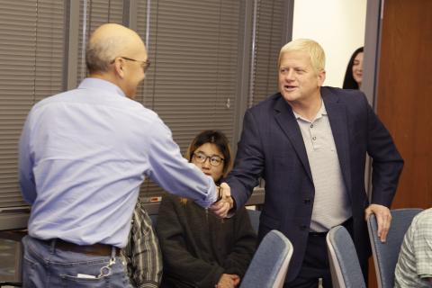Shan-Lu Liu shaking hands with Dean Rustin Moore