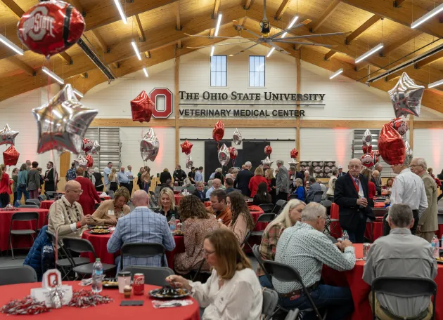 Classmates and friends gather in the Ralph Rogan Equine Performance Evaluation Arena for the college’s Welcome Home Reception.
