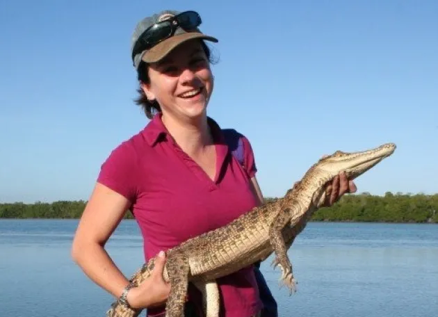 Jay Flint holds a small crocodile